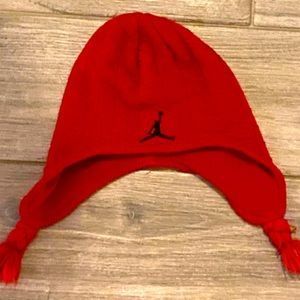 Red Jordan beanie with tassels.